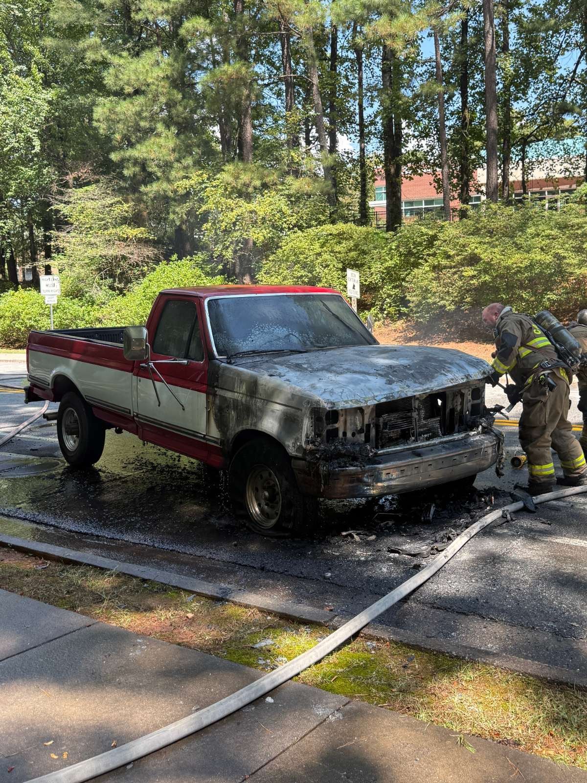 Firefighters putting out the fire on my truck